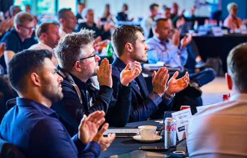 Teilnehmer klatschen im Seminar